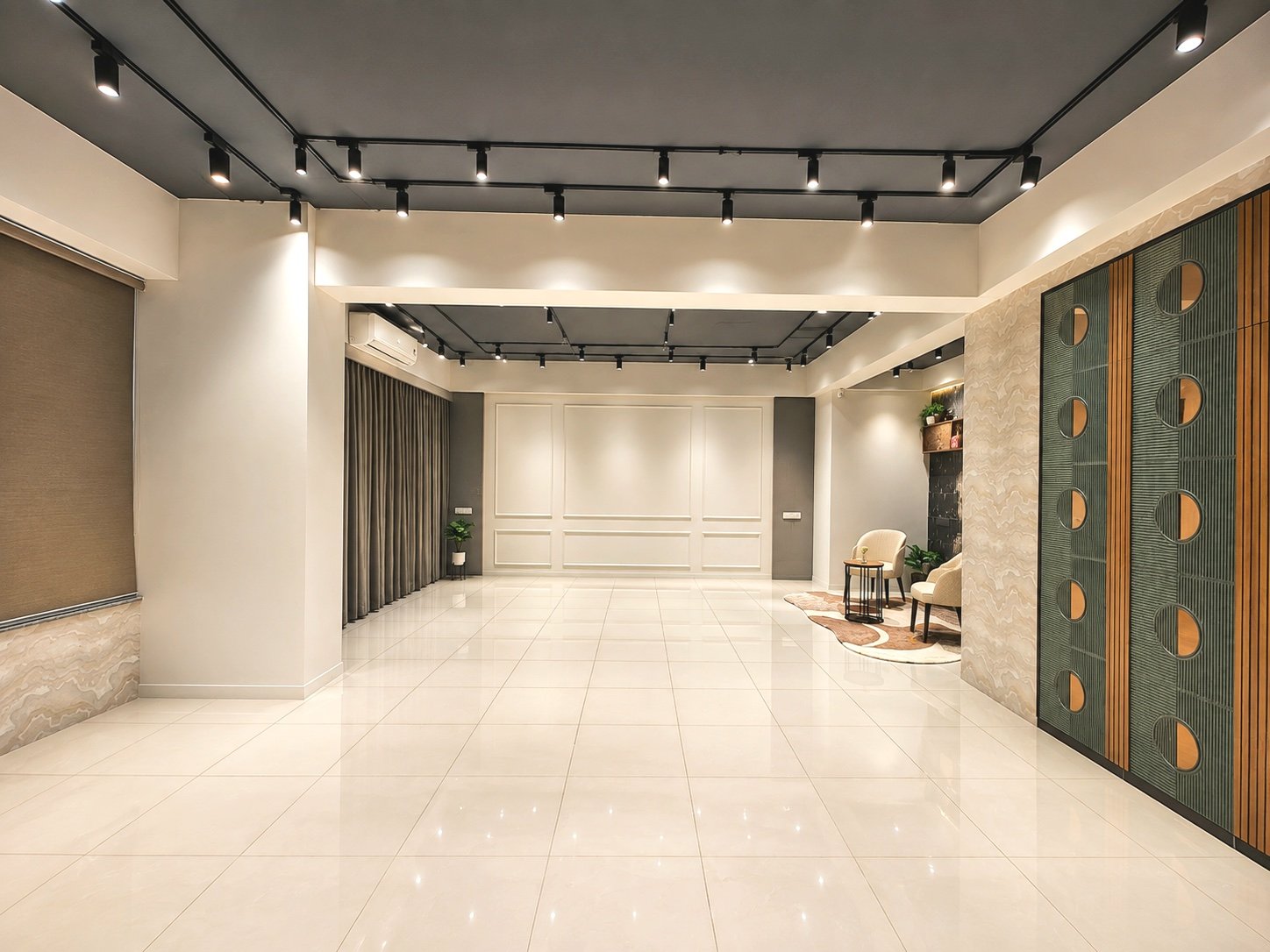 The full length of the main hall at Udaan Studios, with track lighting overhead